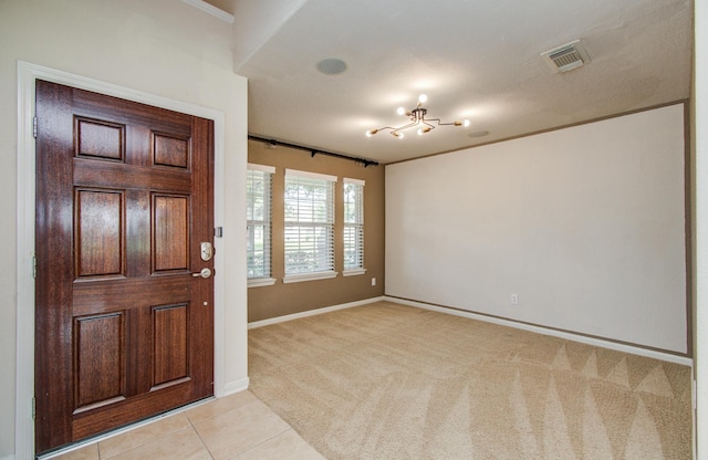 17919 Royal Gate Ln, Richmond, TX 77407 - entryway featuring light carpet, baseboards, and light tile patterned flooring