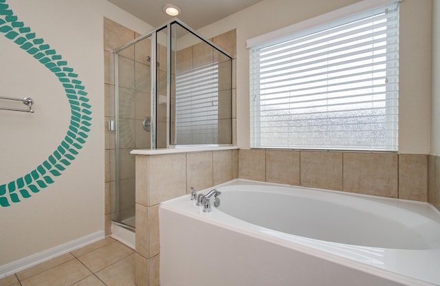 17919 Royal Gate Ln, Richmond, TX 77407 - bathroom featuring a garden tub, a shower stall, tile patterned floors, and baseboards