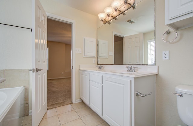 17919 Royal Gate Ln, Richmond, TX 77407 - full bathroom with double vanity, tile patterned flooring, a garden tub, and toilet