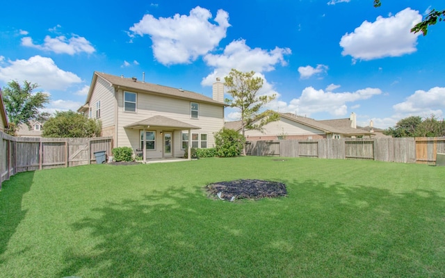 17919 Royal Gate Ln, Richmond, TX 77407 - rear view of property featuring a chimney