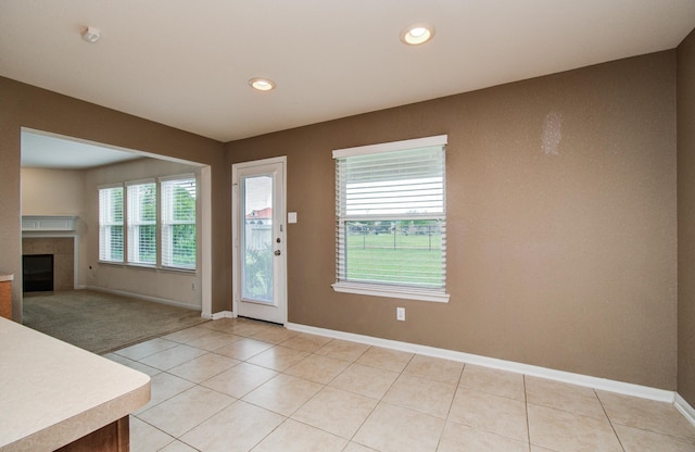 17919 Royal Gate Ln, Richmond, TX 77407 - foyer entrance featuring a tile fireplace, baseboards, light tile patterned floors, and recessed lighting