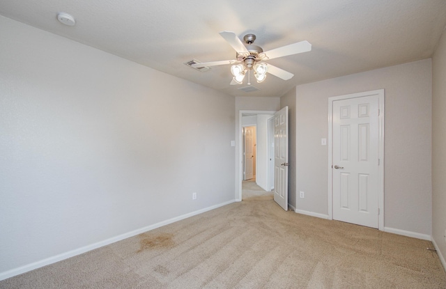 17919 Royal Gate Ln, Richmond, TX 77407 - unfurnished bedroom with light colored carpet, baseboards, and a ceiling fan