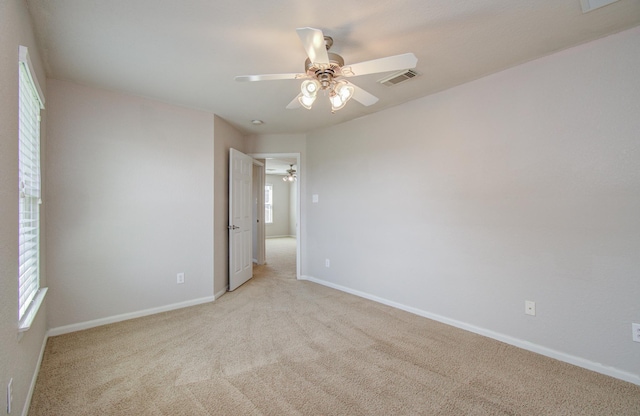 17919 Royal Gate Ln, Richmond, TX 77407 - spare room featuring ceiling fan, light colored carpet, and baseboards