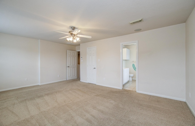 17919 Royal Gate Ln, Richmond, TX 77407 - unfurnished bedroom featuring light carpet, baseboards, and connected bathroom
