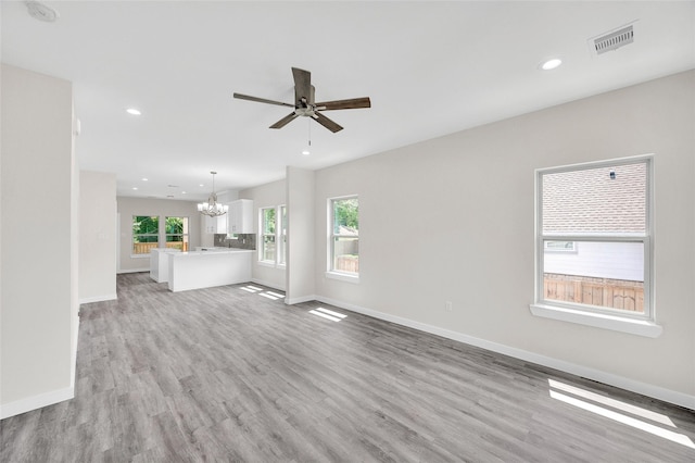 8022 Yoe St, Houston, TX 77078 - unfurnished living room with a chandelier, light wood-style floors, plenty of natural light, recessed lighting, and ceiling fan