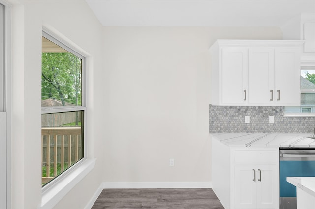 8022 Yoe St, Houston, TX 77078 - kitchen featuring dishwasher, light stone countertops, white cabinets, wood finished floors, and decorative backsplash