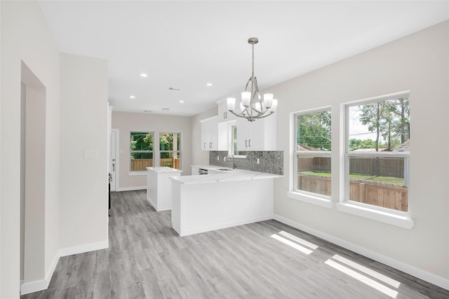 8022 Yoe St, Houston, TX 77078 - kitchen featuring a sink, a chandelier, white cabinets, plenty of natural light, and recessed lighting