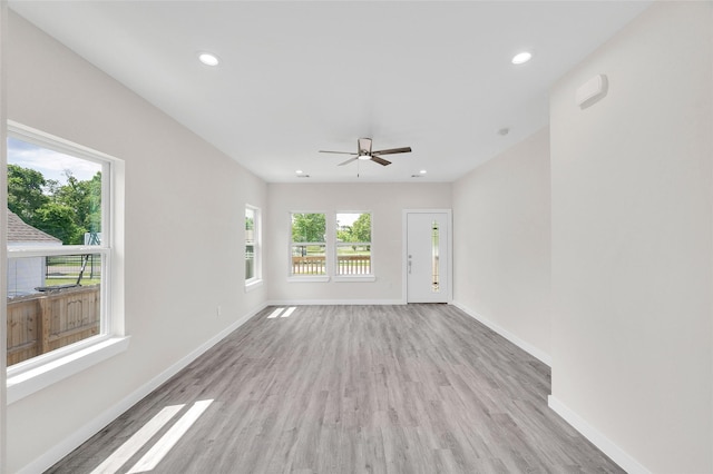 8022 Yoe St, Houston, TX 77078 - unfurnished living room featuring light wood-style flooring, baseboards, recessed lighting, and a ceiling fan