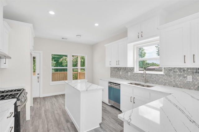 8022 Yoe St, Houston, TX 77078 - kitchen with dishwasher, stainless steel range with gas stovetop, backsplash, plenty of natural light, and recessed lighting