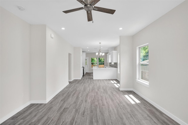 8022 Yoe St, Houston, TX 77078 - unfurnished living room featuring a chandelier, light wood-style flooring, healthy amount of natural light, and recessed lighting