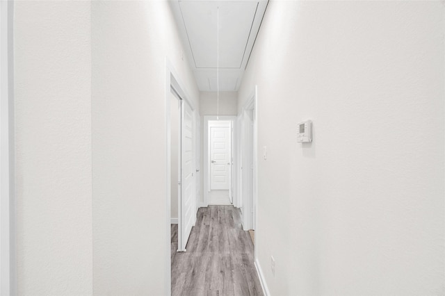 8022 Yoe St, Houston, TX 77078 - corridor with attic access, light wood-style flooring, and baseboards