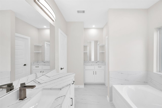 8022 Yoe St, Houston, TX 77078 - full bathroom with two vanities, a garden tub, marble finish flooring, and recessed lighting
