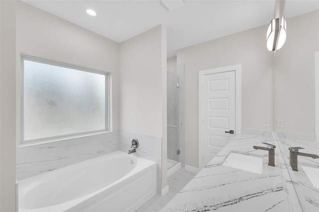 8022 Yoe St, Houston, TX 77078 - bathroom with a bath, marble look tiles, double vanity, a stall shower, and recessed lighting