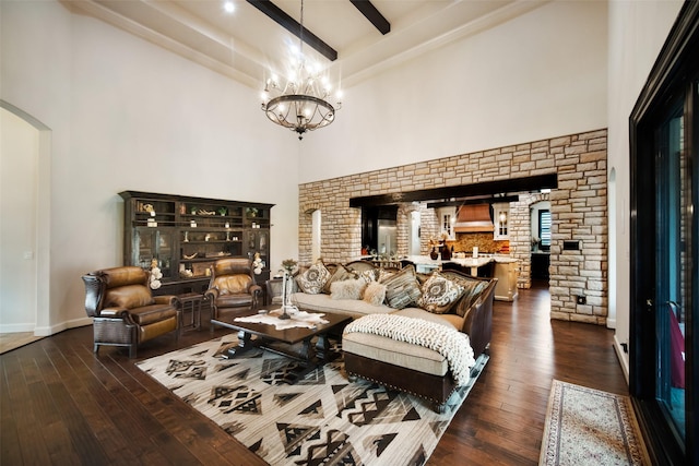 9 Copper Bottom Dr, Tomball, TX 77377 - living area with dark wood finished floors, a towering ceiling, a chandelier, arched walkways, and beamed ceiling