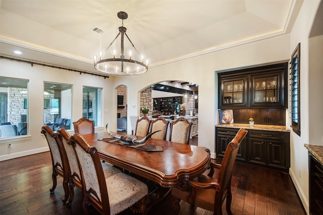 9 Copper Bottom Dr, Tomball, TX 77377 - dining space with arched walkways, a chandelier, dark wood finished floors, baseboards, and recessed lighting