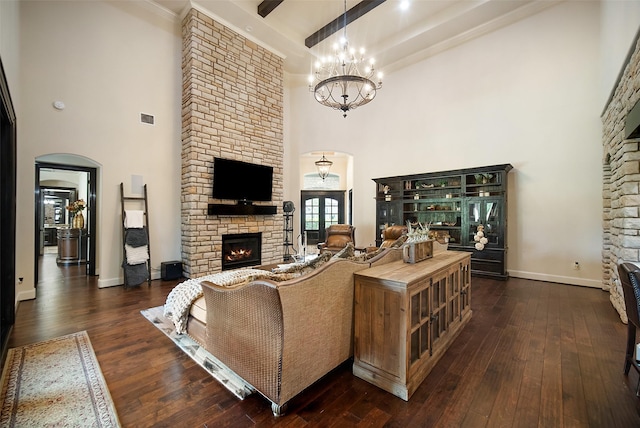 9 Copper Bottom Dr, Tomball, TX 77377 - living area featuring a high ceiling, arched walkways, a fireplace, dark wood-style flooring, and a chandelier