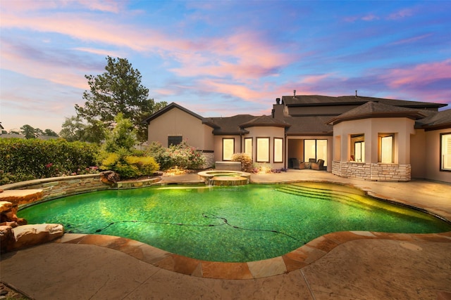 9 Copper Bottom Dr, Tomball, TX 77377 - pool at dusk with a pool with connected hot tub and a patio area