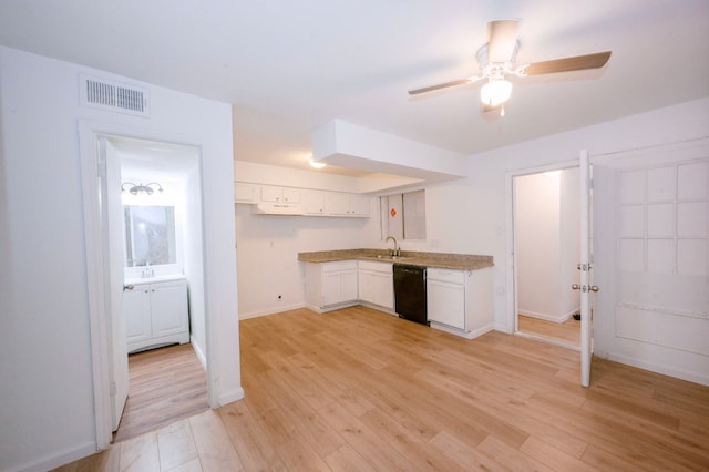 12048 Beechnut St, Houston, TX 77072 - kitchen featuring dishwasher, white cabinetry, and light wood finished floors