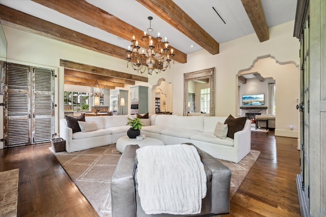 1915 Kirby Dr, Houston, TX 77019 - living area with a chandelier, beamed ceiling, dark wood-type flooring, arched walkways, and baseboards