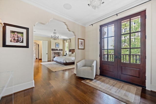 1915 Kirby Dr, Houston, TX 77019 - bedroom with a chandelier, ornamental molding, dark wood-type flooring, french doors, and baseboards