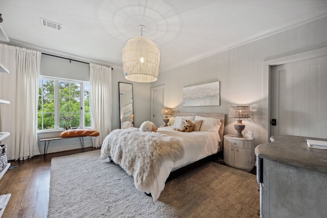 1915 Kirby Dr, Houston, TX 77019 - bedroom with ornamental molding, wood finished floors, and a chandelier