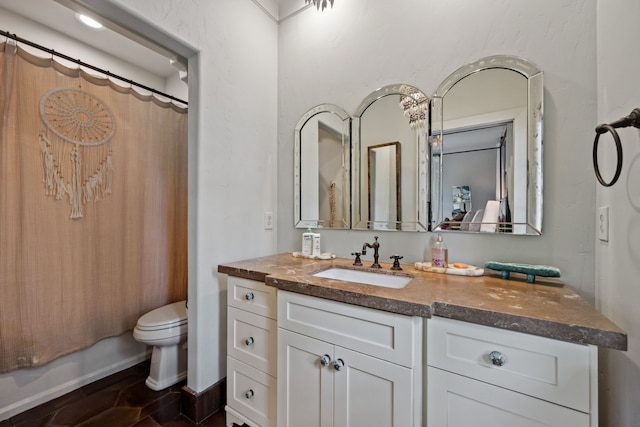 1915 Kirby Dr, Houston, TX 77019 - bathroom featuring vanity, toilet, and shower / tub combo with curtain