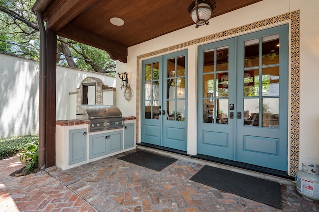 1915 Kirby Dr, Houston, TX 77019 - property entrance with french doors, an outdoor kitchen, and a patio area
