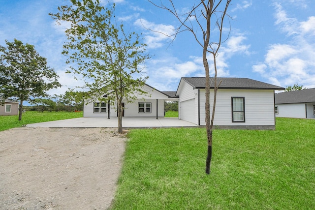 5046 Muske Ln, Brookshire, TX 77423 - rear view of house with a yard, driveway, an attached garage, and a patio area