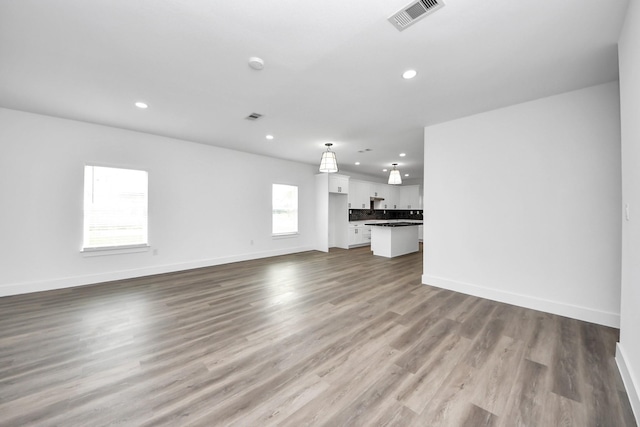 5046 Muske Ln, Brookshire, TX 77423 - unfurnished living room featuring recessed lighting, wood finished floors, and baseboards