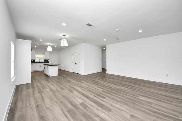 5046 Muske Ln, Brookshire, TX 77423 - unfurnished living room with recessed lighting, baseboards, and light wood-style floors