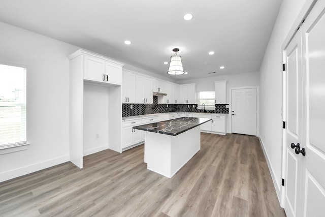 5046 Muske Ln, Brookshire, TX 77423 - kitchen with recessed lighting, white cabinetry, tasteful backsplash, a kitchen island, and baseboards