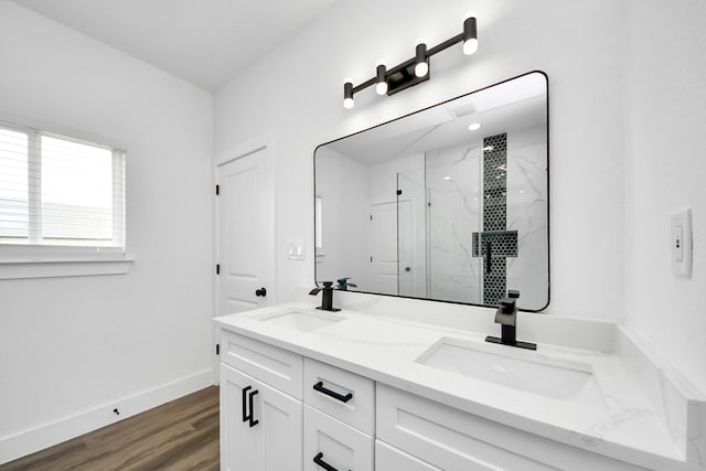 5046 Muske Ln, Brookshire, TX 77423 - bathroom with a marble finish shower, double vanity, wood finished floors, and baseboards
