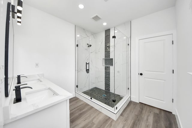 5046 Muske Ln, Brookshire, TX 77423 - bathroom with wood finished floors, a marble finish shower, recessed lighting, and double vanity
