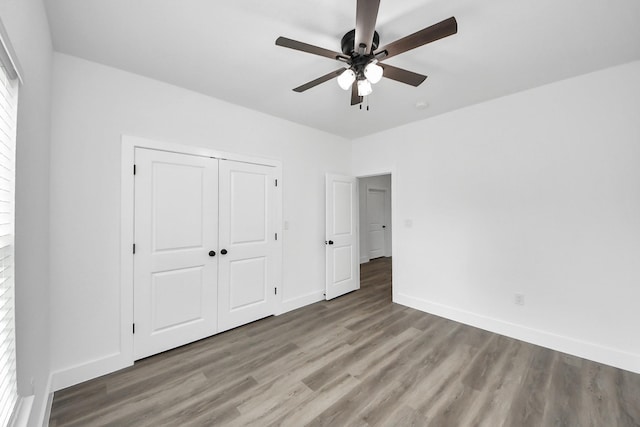 5046 Muske Ln, Brookshire, TX 77423 - unfurnished bedroom with wood finished floors, baseboards, a closet, and a ceiling fan