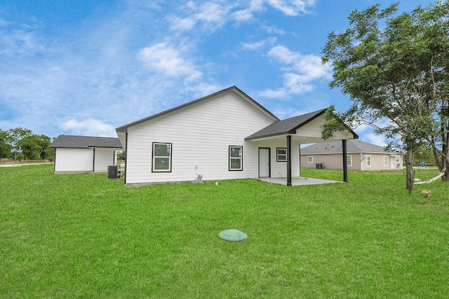 5046 Muske Ln, Brookshire, TX 77423 - back of property featuring a patio area, a lawn, and central AC unit
