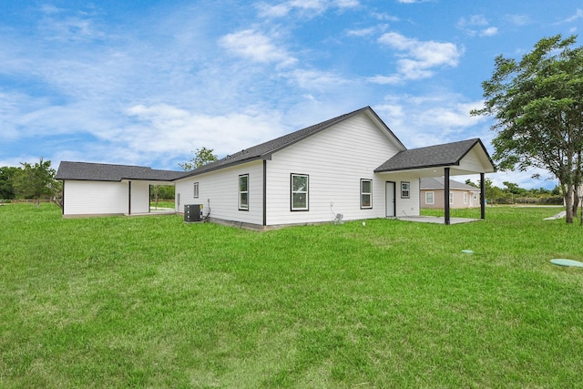 5046 Muske Ln, Brookshire, TX 77423 - rear view of property with central air condition unit, a yard, a patio, and a shingled roof