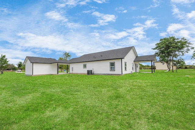 5046 Muske Ln, Brookshire, TX 77423 - rear view of house with a lawn and central AC unit