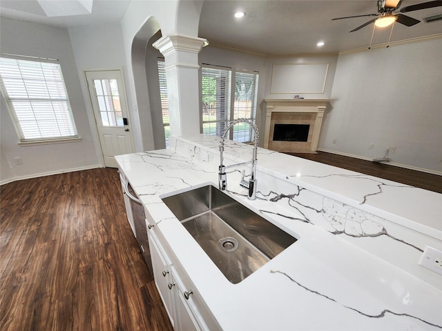 2927 Cambry Crossing Ct, Katy, TX 77494 - kitchen with a sink, ornate columns, dark wood-style floors, arched walkways, and recessed lighting
