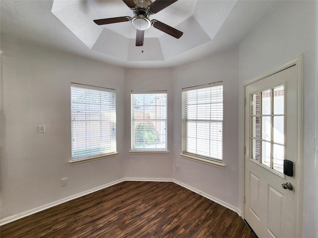 2927 Cambry Crossing Ct, Katy, TX 77494 - unfurnished room featuring a raised ceiling, dark wood finished floors, baseboards, and a ceiling fan