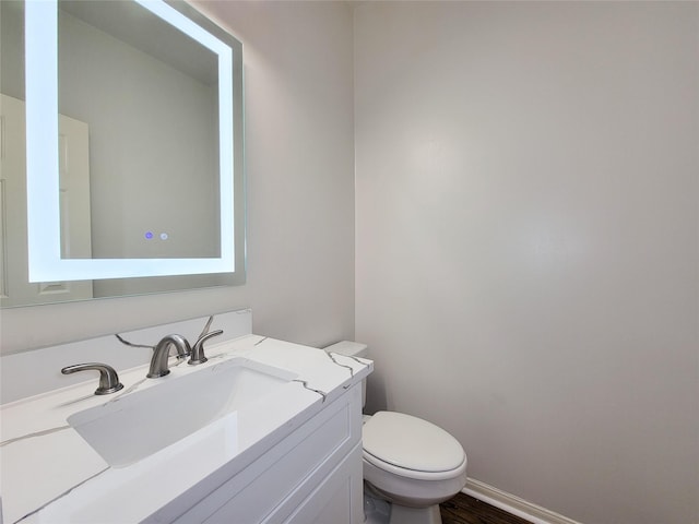 2927 Cambry Crossing Ct, Katy, TX 77494 - bathroom featuring toilet, vanity, wood finished floors, and baseboards