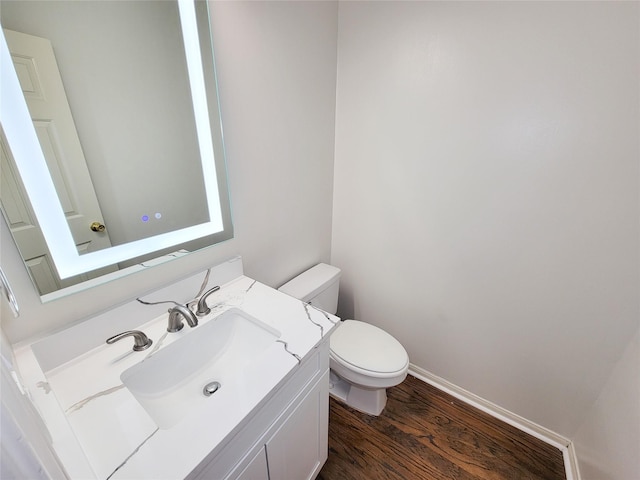 2927 Cambry Crossing Ct, Katy, TX 77494 - bathroom featuring toilet, wood finished floors, vanity, and baseboards
