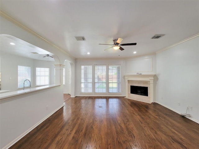 2927 Cambry Crossing Ct, Katy, TX 77494 - unfurnished living room featuring a ceiling fan, arched walkways, ornamental molding, plenty of natural light, and recessed lighting