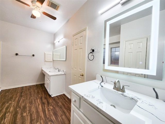2927 Cambry Crossing Ct, Katy, TX 77494 - bathroom featuring a ceiling fan, wood finished floors, two vanities, and baseboards