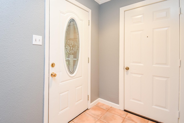 1102 Ashdale Dr, Sugar Land, TX 77498 - foyer featuring light tile patterned floors, a textured wall, and baseboards