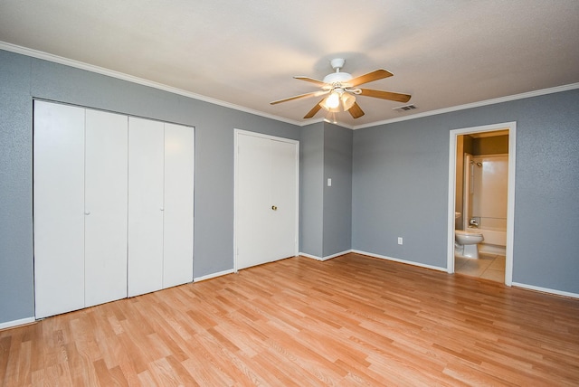 1102 Ashdale Dr, Sugar Land, TX 77498 - unfurnished bedroom with two closets, light wood-style floors, ornamental molding, baseboards, and ensuite bathroom