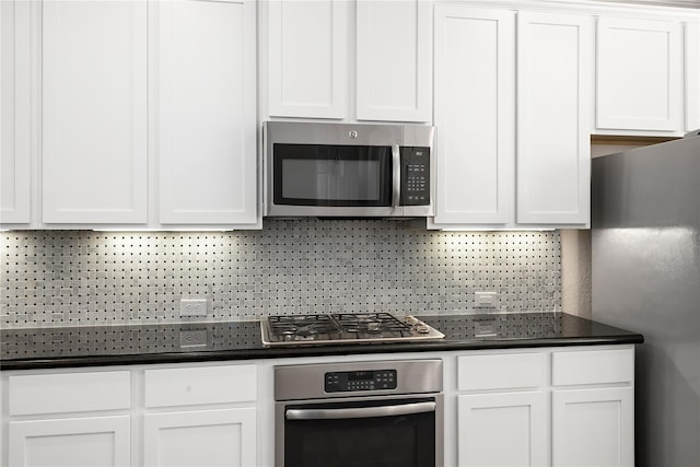 1511 Peyton Oaks Pl, Houston, TX 77043 - kitchen with stainless steel appliances, dark countertops, and white cabinets