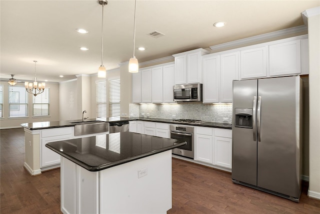 1511 Peyton Oaks Pl, Houston, TX 77043 - kitchen featuring appliances with stainless steel finishes, a sink, a peninsula, dark countertops, and recessed lighting