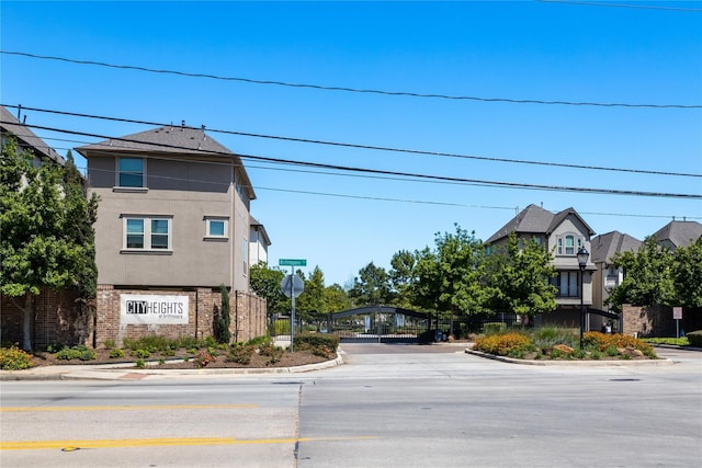 1511 Peyton Oaks Pl, Houston, TX 77043 - view of asphalt road featuring curbs and traffic signs