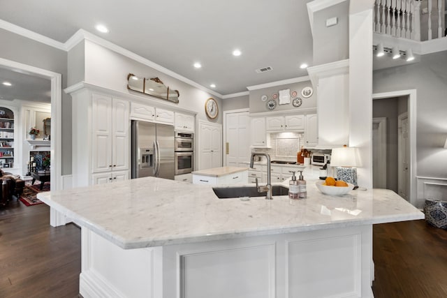 1714 Chestnut Grove Ln, Houston, TX 77345 - kitchen featuring appliances with stainless steel finishes, a sink, crown molding, white cabinets, and light stone counters