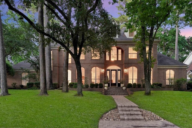1714 Chestnut Grove Ln, Houston, TX 77345 - view of front of home featuring brick siding and a lawn
